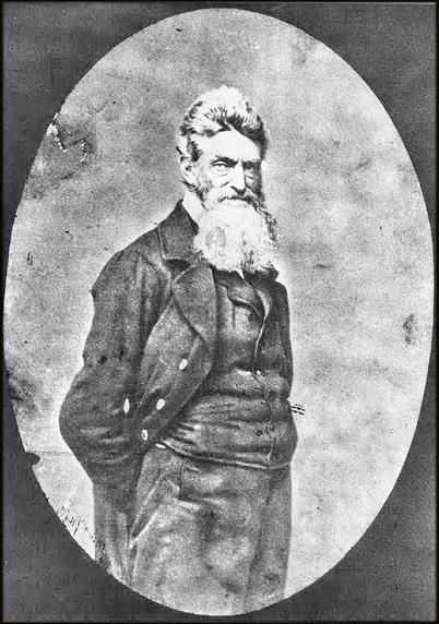 John Brown in 1859. He is turned to the side with his face turned towards the camera.  He has his right hand in his pocket.