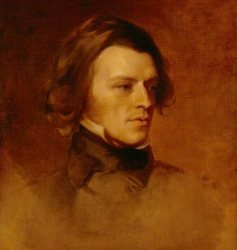 Portrait of Alfred Lord Tennyson by Samuel Laurence, 1840.

Tennyson is portrayed with abundant dark chestnut hair swept back from a strong, angular face, gazes slightly to his left. The features are sharply defined — a prominent nose, firm jaw, deep-set eyes — and a loose dark coat with white collar.

https://commons.wikimedia.org/wiki/File:Alfred_Lord_Tennyson_1840.jpg