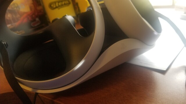 PSVR2 controllers on the charging stand with a little white line showing up through the plastic housing