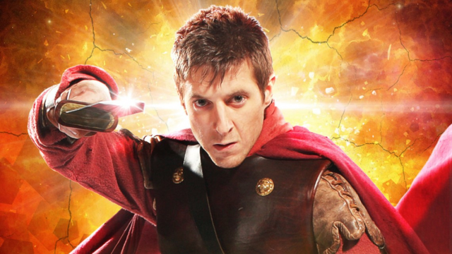 A promo shot from Dr Who featuring The Lone Centurian, dressed in a roman cloak, armour, and welding a sword towards the camera.