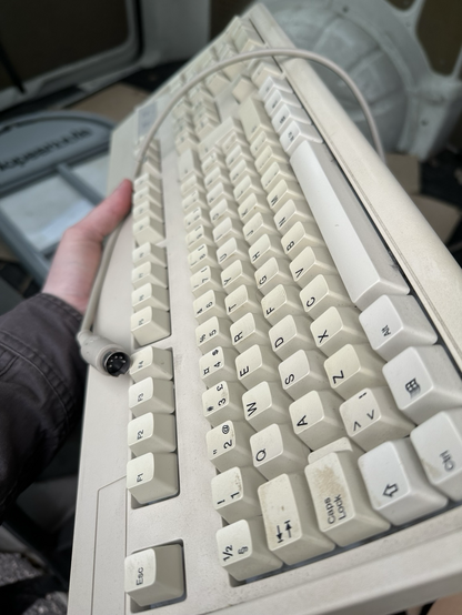 A cream colored classic PC keyboard. 