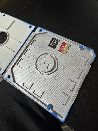 The inside of the same microSD card storage solution. There are 11 slots for cards. The first two are full and 3-11 are currently empty.