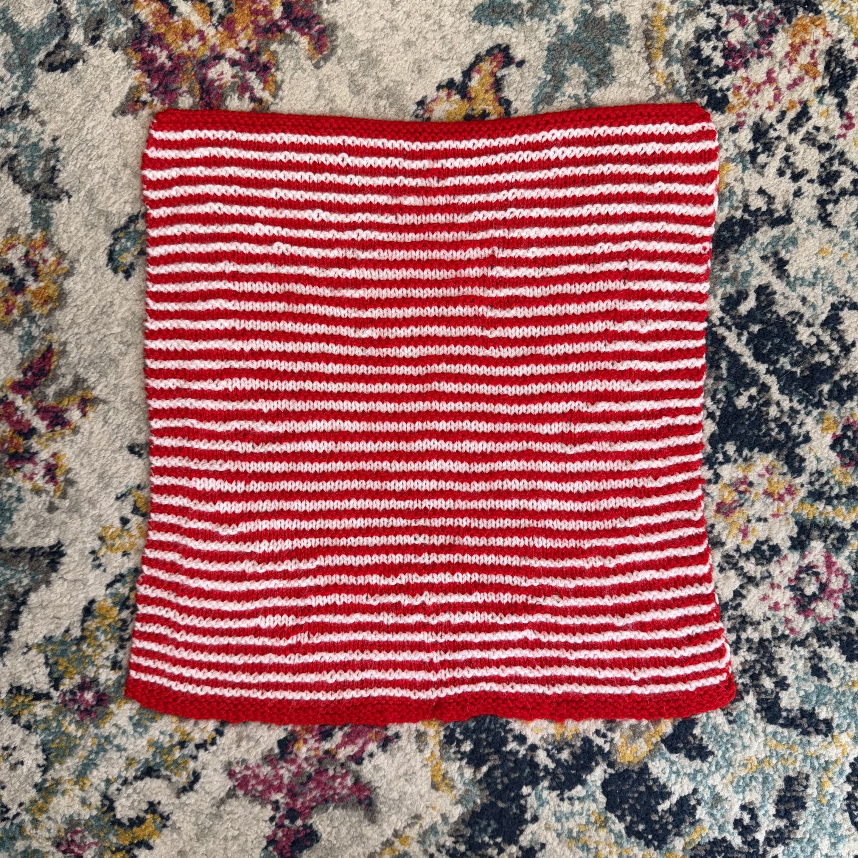 Knitting viewed top down. It’s just red and white stripes. Knitting viewed top down. It’s just red and white stripes.