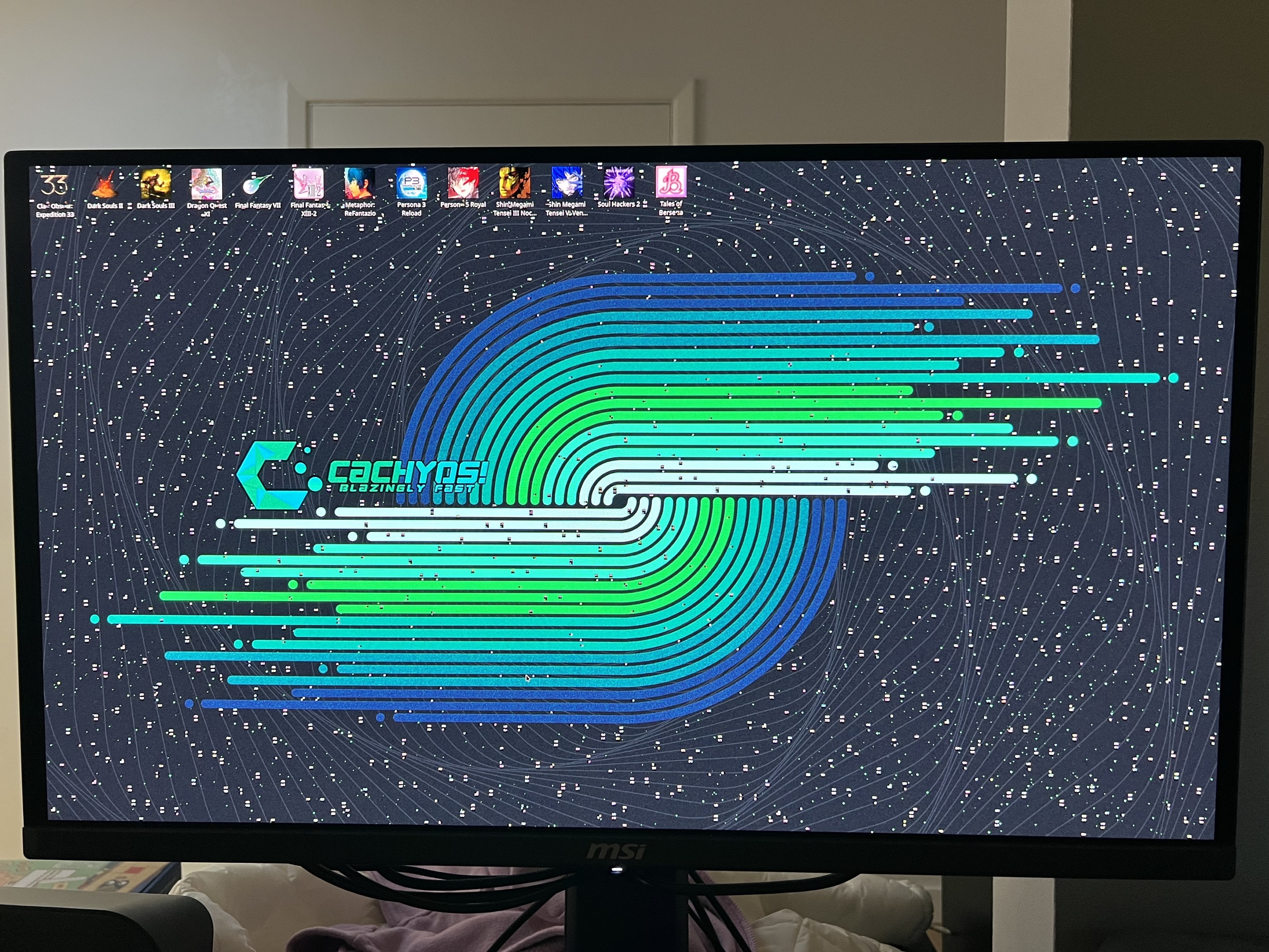 My computer monitor showing a CachyOs desktop wallpaper with bunch of weird spots all over.