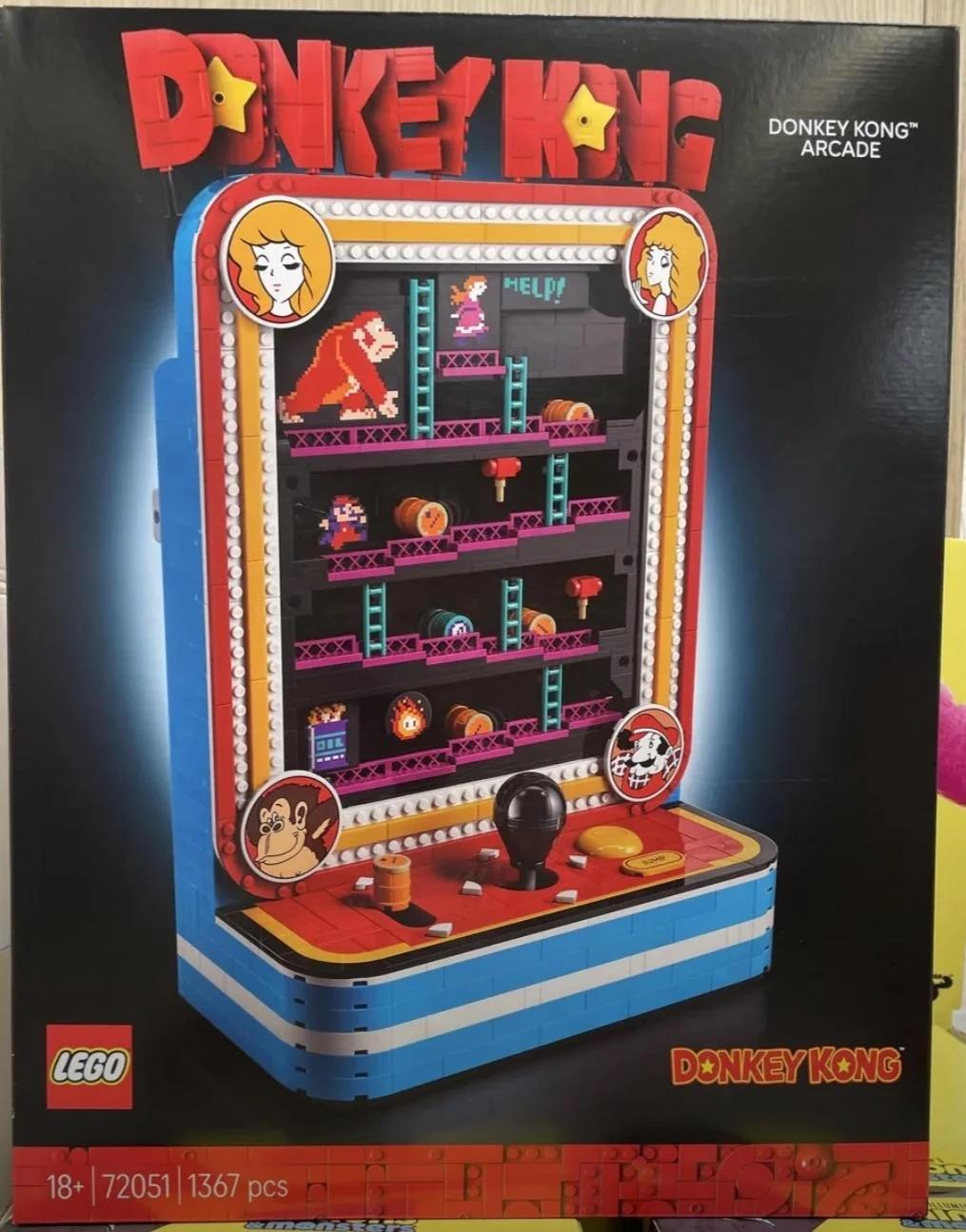 A LEGO Donkey Kong Arcade set box featuring a brick‑built retro arcade cabinet styled after the classic Donkey Kong game. The front shows Mario climbing ladders, Donkey Kong at the top holding Pauline captive, and pixel‑style barrels rolling down the ramps. The LEGO model on the box mimics the original arcade machine with a joystick, buttons, and layered platforms. The packaging uses bright red and blue accents with the Donkey Kong logo, and the set is displayed against a dark background that makes the colourful bricks stand out.