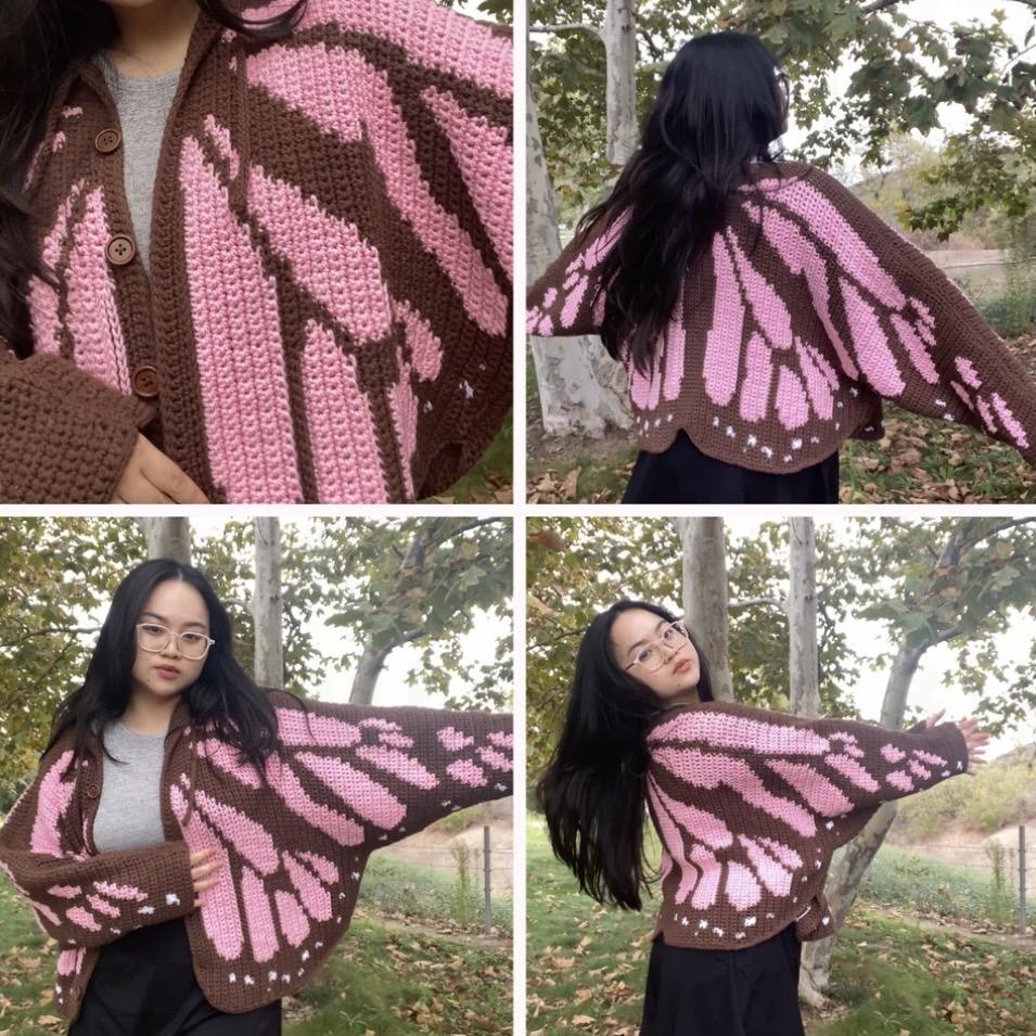 A collage of four photos shows a woman outdoors wearing a handmade crochet cardigan with a butterfly wing design. The cardigan is brown with pink wing patterns and wooden buttons. In the top-left image, there’s a close-up of the textured stitches and buttoned front. The top-right image shows the back view, where the butterfly wing pattern spreads across her outstretched arms. The bottom two images show her posing in front of trees with green leaves and fallen autumn foliage, highlighting the cardigan’s flowing shape and vivid colors.